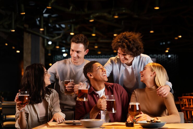 medium-shot-happy-friends-sitting-pub_23-2148872463